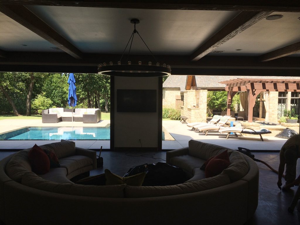 view of the pool from the family room with folding doors open