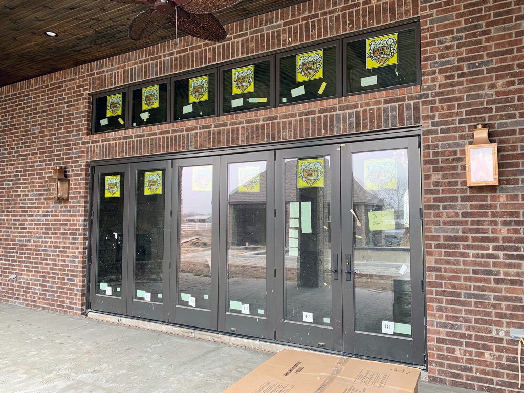 aluminum clad wood folding door system with an aluminum clad wood transom